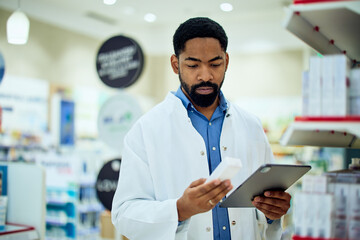 Pharmacist Examining Medicine Box and Clipboard in a Modern Pharmacy