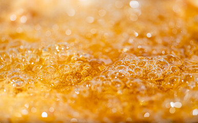 Close up bright orange Oil or beer splash texture and nature waves, Beautiful waves curve and...