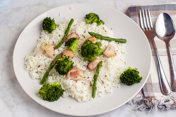 rice  and chicken with broccoli , asparagus and parsley