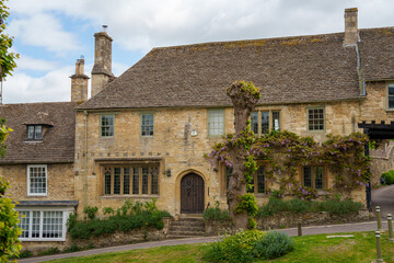 Traditional Stone Cottages Along a Curved Road in the Cotswolds, England