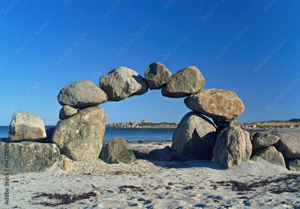 Aufkleber a stone archway delicately balanced on a sandy beach, framing a tranquil ocean view under a vibrant 