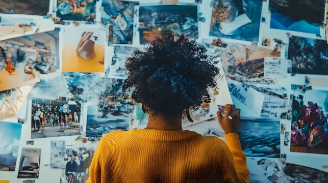 Person creating a vision board filled with images of their goals