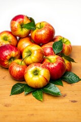 A vibrant still life of freshly picked apples, arranged artfully in a woven basket or a shallow, ornate bowl, set against a soft, creamy background