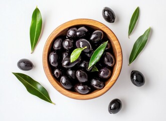 Fototapeta na wymiar A wooden bowl filled with glistening black olives, surrounded by fresh green olive leaves on a pristine white surface. The olives appear ripe and juicy, ready to be enjoyed. : Generative AI