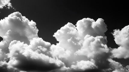 Dramatic black and white image of fluffy cumulus clouds against a dark sky, creating a striking contrast and texture. : Generative AI