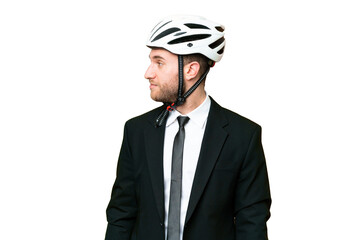Business person with a bike helmet over isolated chroma key background looking to the side