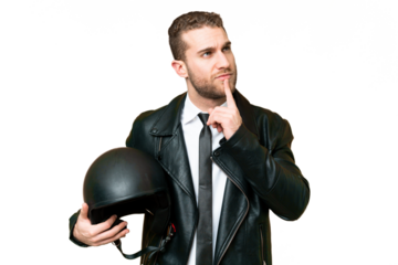 Business man with a motorcycle helmet over isolated chroma key background having doubts while looking up