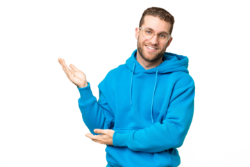 Young handsome blonde man over isolated chroma key background extending hands to the side for inviting to come