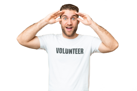 Young volunteer man over isolated chroma key background with surprise expression