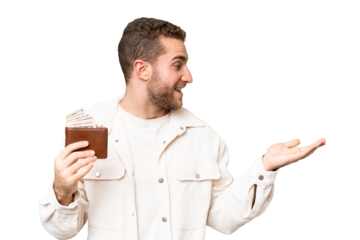 Young handsome blonde man holding a wallet over isolated chroma key background with surprise facial expression