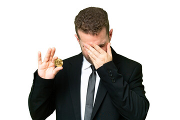 Young business blonde man holding a Bitcoin over isolated chroma key background with tired and sick expression