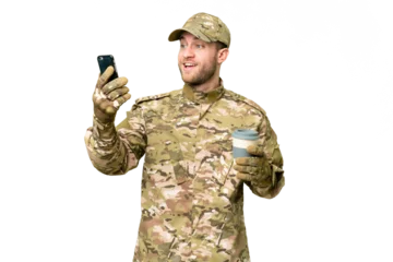 Vitrage gordijnen Military man over isolated chroma key background holding coffee to take away and a mobile © luismolinero