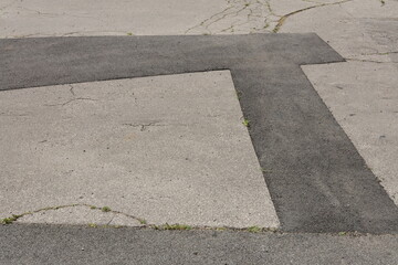 asphalt pavement with cracks and patches