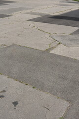 asphalt pavement with cracks and patches