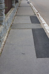 asphalt pavement with cracks and patches