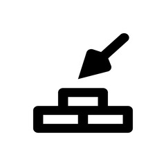 Black silhouette of a trowel pointing down towards a stylized brick wall in a simple vector graphic style