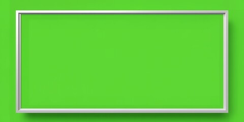 Simple rectangular silver frame surrounding a vibrant green background on a green wall