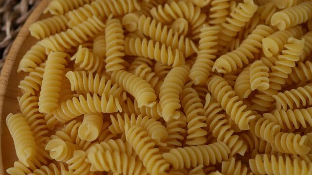 Raw Fusilli Spiral spaghetti pasta pattern background.