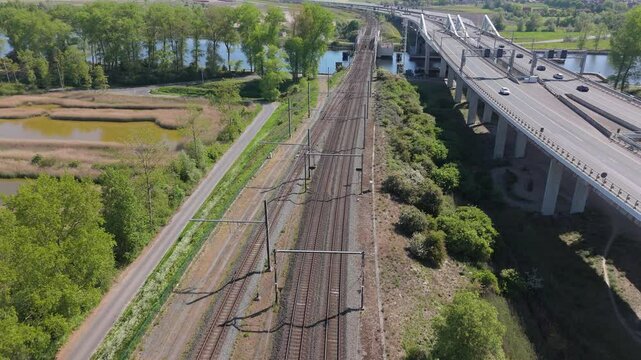 Train Crossing Railway Bridge over Water beside A11 | 4K Drone by FlyLens
