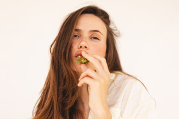 Close up portrait of lovely sweet attractive feminine glamorous wavy-haired lady eating biting...