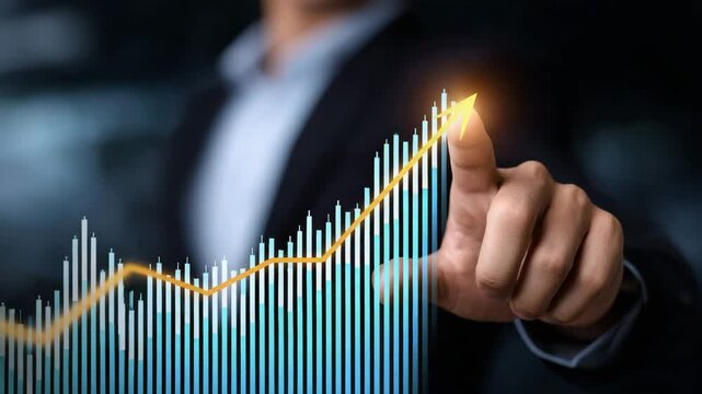 A business professional pointing at a rising stock graph for investment success.