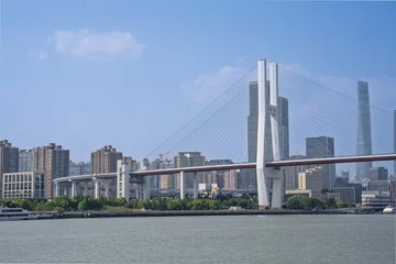 Shanghai Nanpu Bridge and city skyline under blue sky