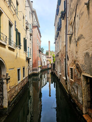 Picturesque view of a Venice canal taken from a bridge. Historic buildings with colorful facades