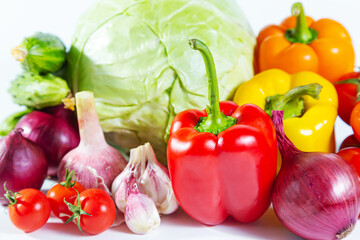 Mix of colorful vegetables - bell pepper, cabbage, tomatoes, cucumbers, onions and garlic.