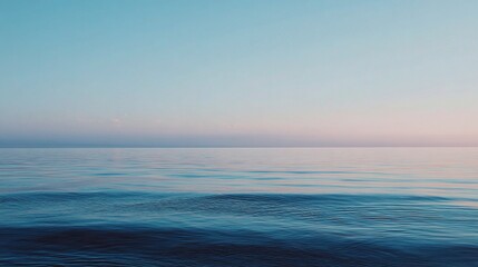Obraz premium Tranquil Seascape with Calm Horizon and Pale Sky at Dusk