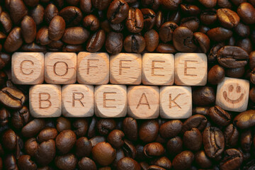Coffee break concept with wooden letter blocks and roasted coffee beans