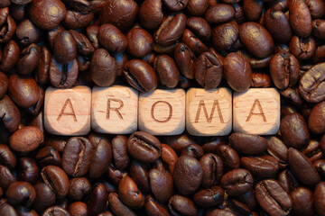 Aroma word on wooden blocks surrounded by coffee beans