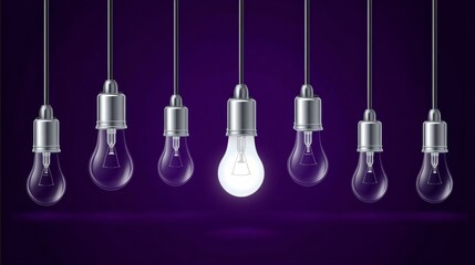 A collection of hanging light bulbs with one illuminated bulb in the center