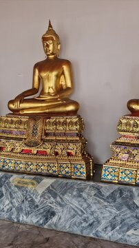 row of golden buddhas of Wat Pho temple - Wat Phra Chetuphon Wimon Mangkhalaram Rajwaramahawihan in Bangkok, Thailand without people