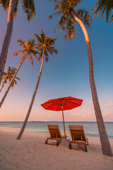 Romantic sunset beach chairs on tropical shore with palm trees, golden sand, calm ocean waves colorful sky. Exotic travel, tourism vacation, relaxation paradise perfect. Summer island shore landscape
