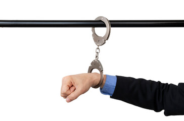 businessman's hand handcuffed to a pipe, anti-corruption concept, cut out, with copy space.