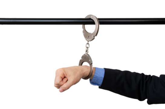 businessman's hand handcuffed to a pipe, anti-corruption concept, cut out, with copy space.