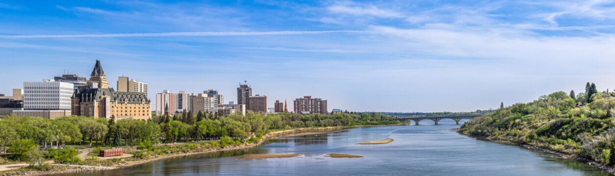 Wide angle panoramic view of north bank of the river around downtown Saskatoon, Canada