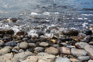 Serene Shoreline with Smooth Stones and Gentle Waves