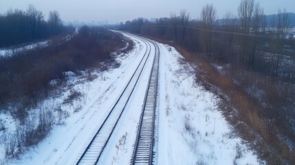 Obraz premium Winter Railway Landscape: A Serene Snow-Covered Track Winding Through a Frosty Winter Wonderland