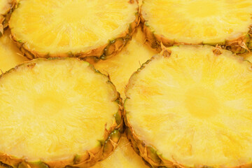 Pineapple juicy yellow slices as a background.