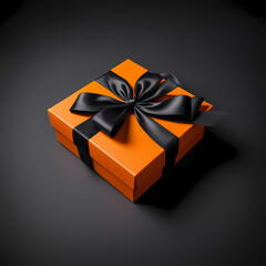 A vibrant orange gift box with a luxurious black ribbon bow, creating a contrast between colors and textures, isolated 
