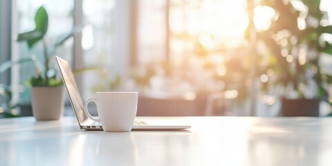 A white coffee mug rests beside a silver laptop on a bright, sunlit table, near potted plants; a tranquil workspace scene. : Generative AI