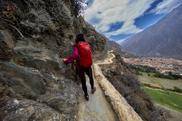 Majestic view of the Ollantaytambo archaeological site in Cusco, Peru. Massive stone terraces rise against the Andean mountains, showcasing the architectural mastery and engineering of the Incas. 