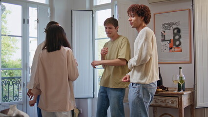 Fototapeta premium Dancing youngsters having fun at home party. Happy friends enjoy discotheque