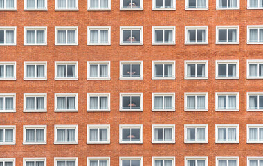 A symmetrical view of a multi story brick building facade in Madrid