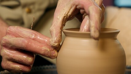 Close up master hands man craft hobby sculpting clay pottery wheel ceramic workshop work process small business artisan job craftsman potter shaping pot jar vase earthenware class studio male handmade