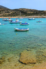 Boats moored in the bay of Kalotaritissa Beach. Amorgos, Cyclades, Greece