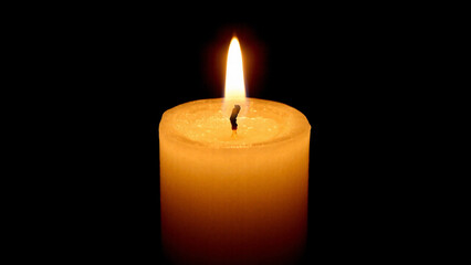 A flickering candle flame in darkness, bringing warmth of peace and hope.