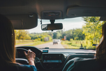 View from the car on the road while driving in the spring