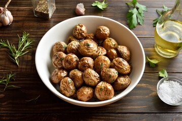 Roasted baby potatoes on wooden table